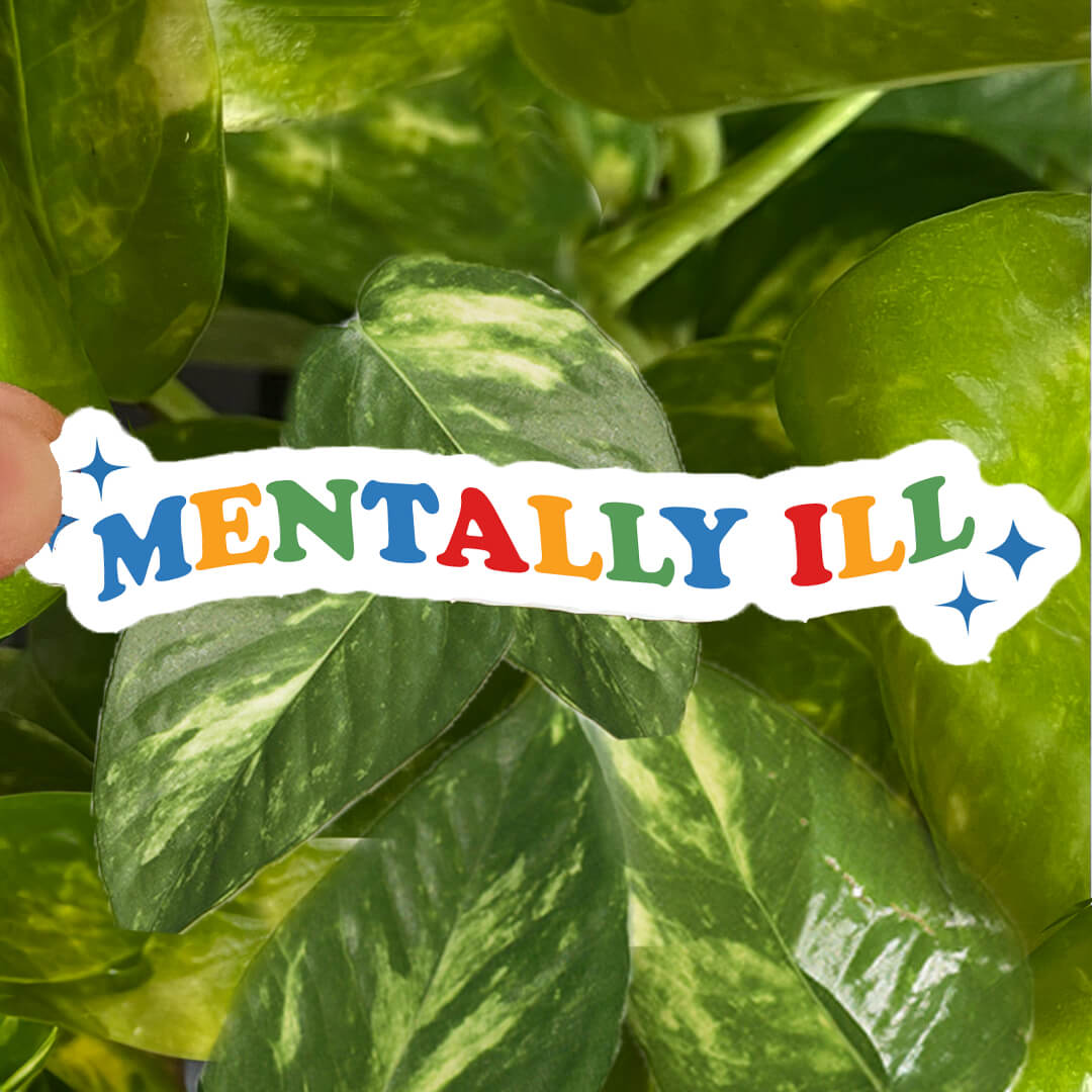 Sticker with blue, green, yellow, and red text reading "mentally ill" with star accents.