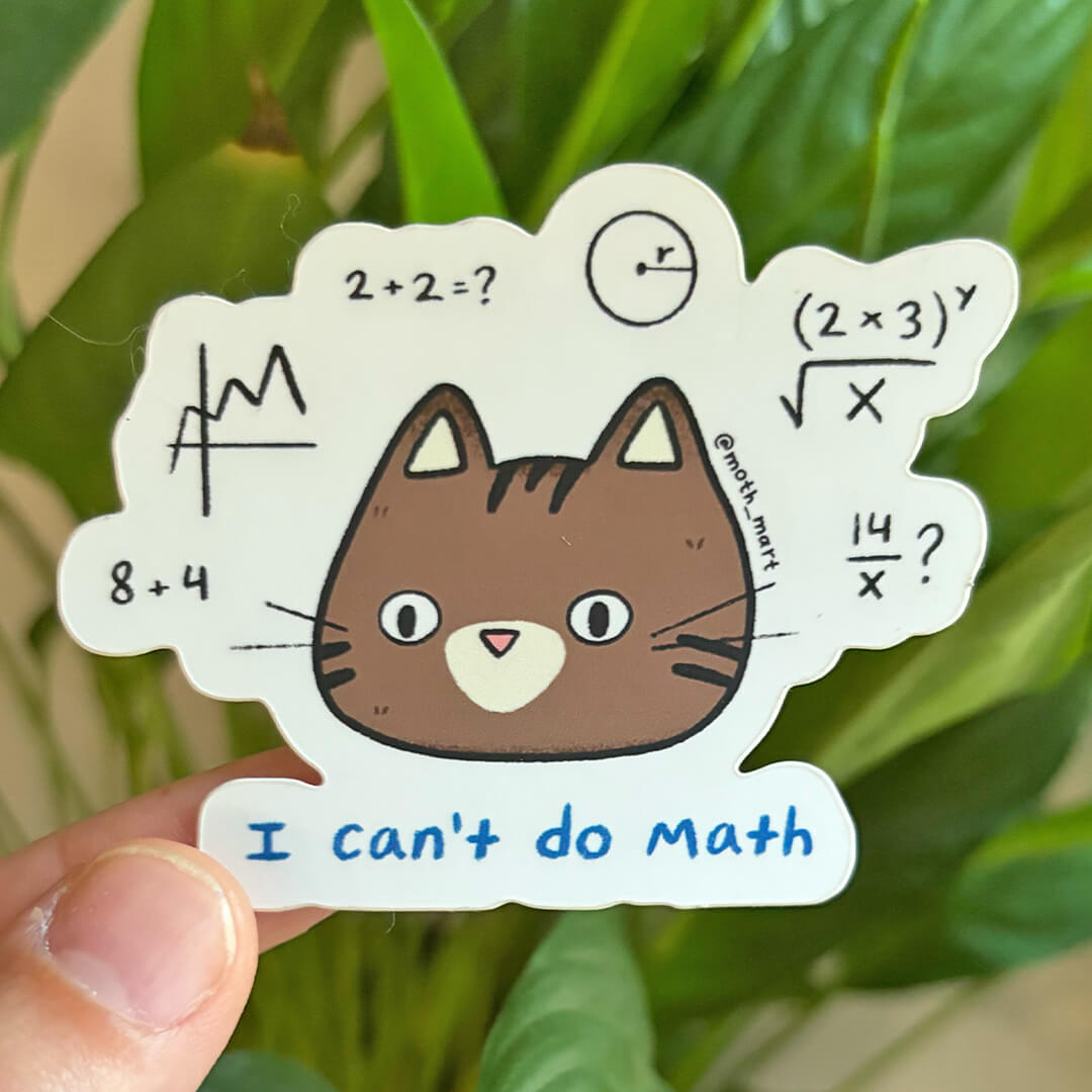 Die cut sticker of a cat with math problems around it with the text "I can't do math" being held by a hand in front of leaves