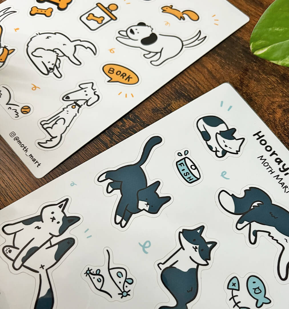 Cute cartoon stickers feature playful dogs, cats, and pet accessories on a wooden table. The tones are cheerful and whimsical, with lively animal poses.