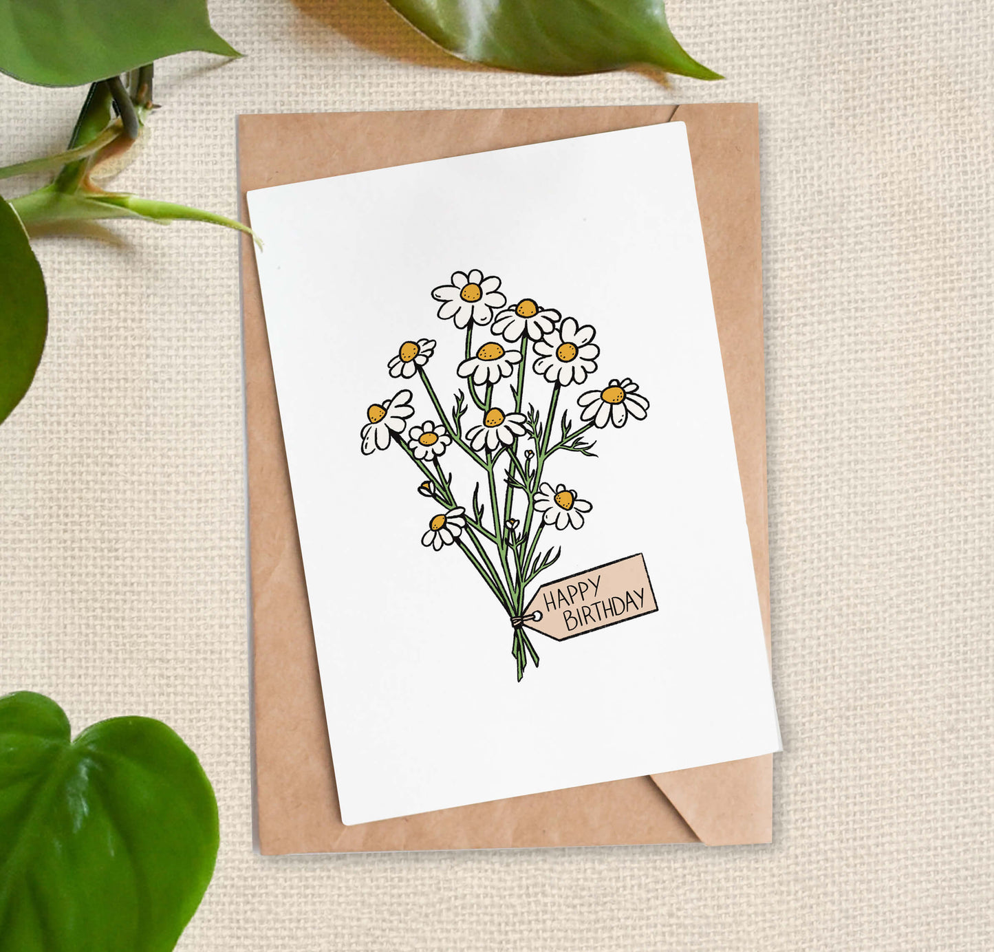 Greeting card illustration of bundle of daisies, tied with a "Happy Birthday" tag. 