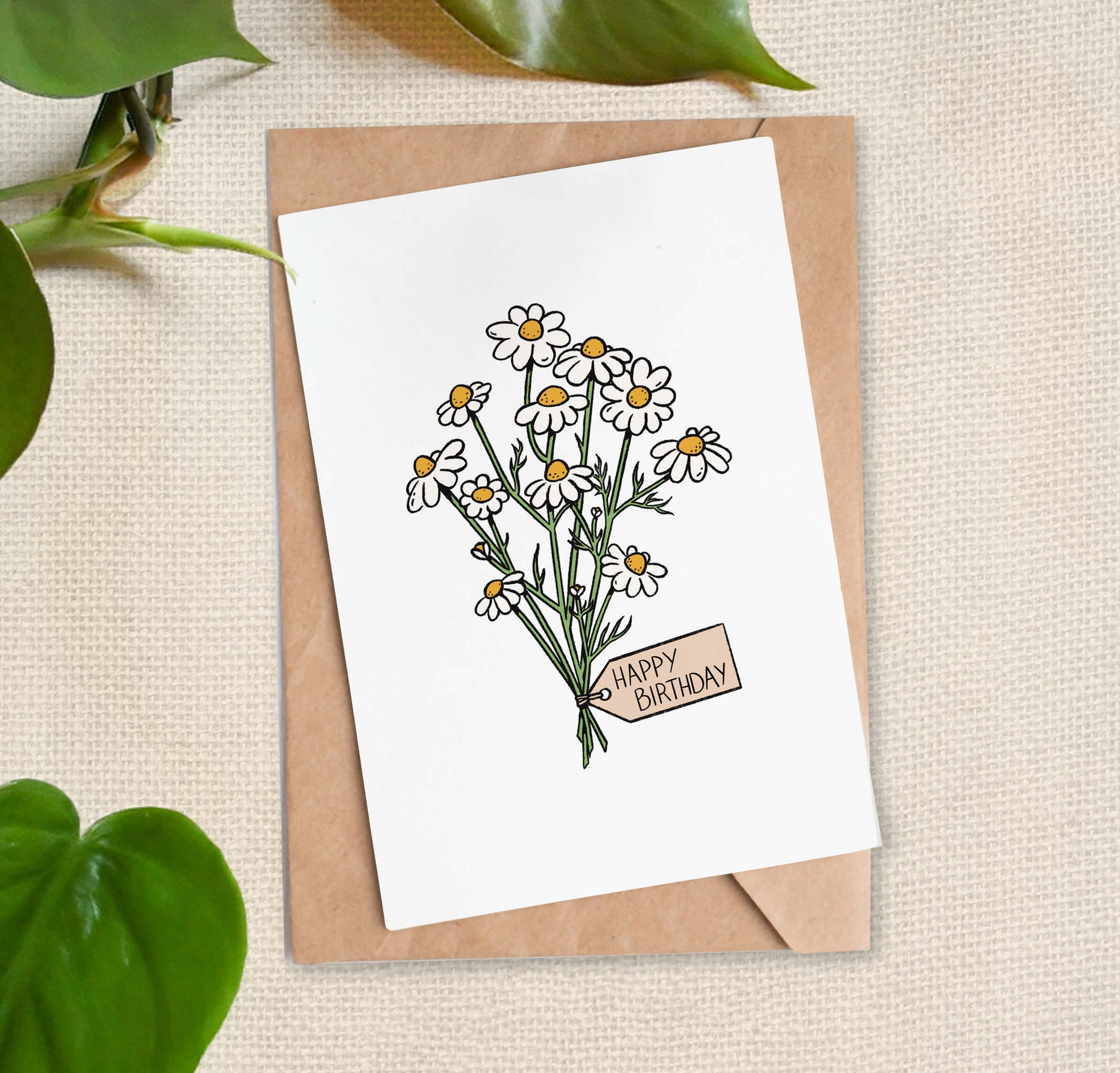 Greeting card illustration of bundle of daisies, tied with a "Happy Birthday" tag. 