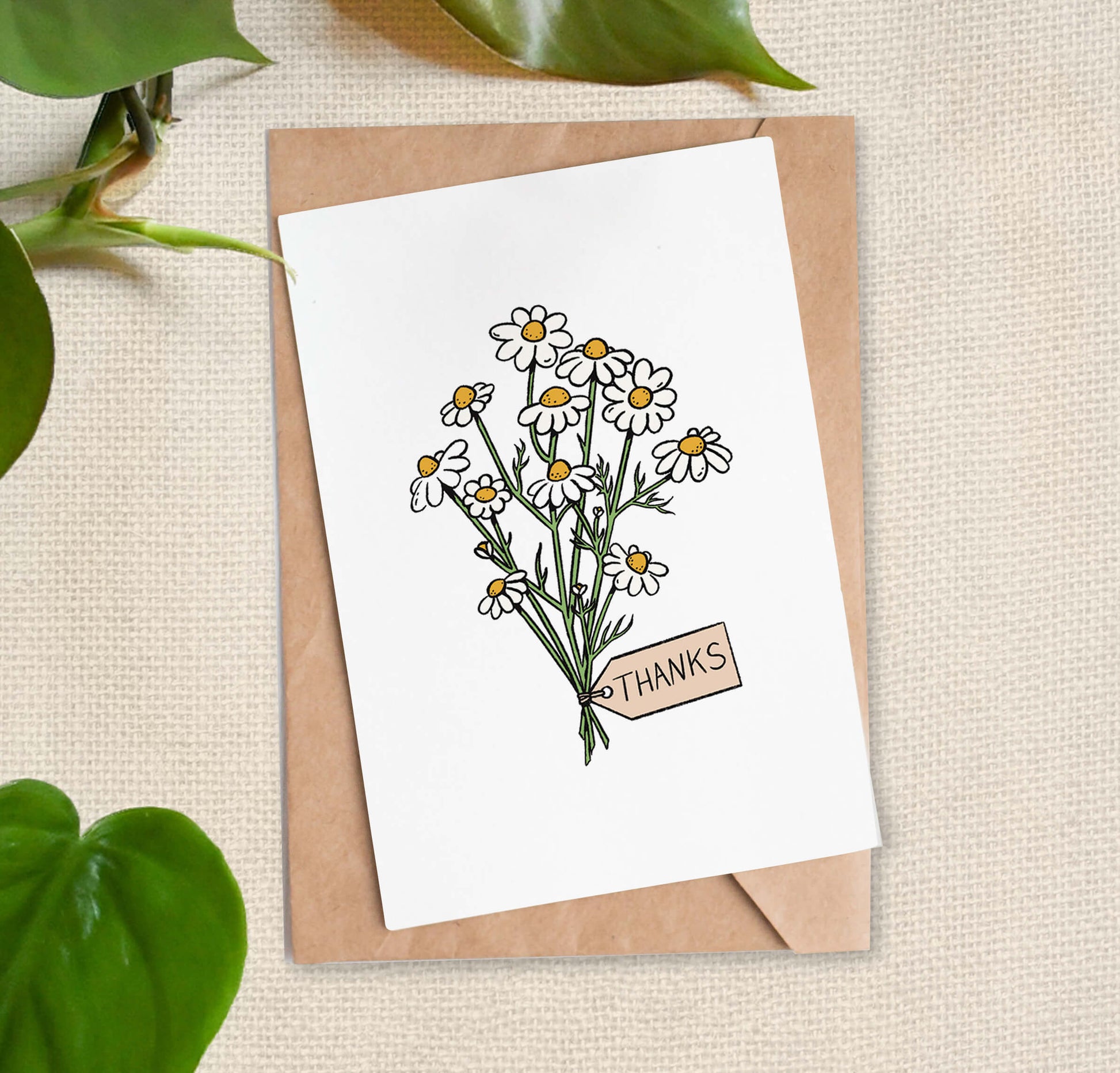 Greeting card illustration of bundle of white daisies, tied with a "thanks" tag. 
