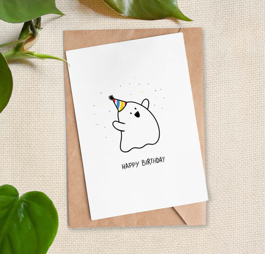 Cartoon of happy sheet ghost wearing a yellow, blue, and red party hat, throwing confetti with text reading "HAPPY BIRTHDAY". 
