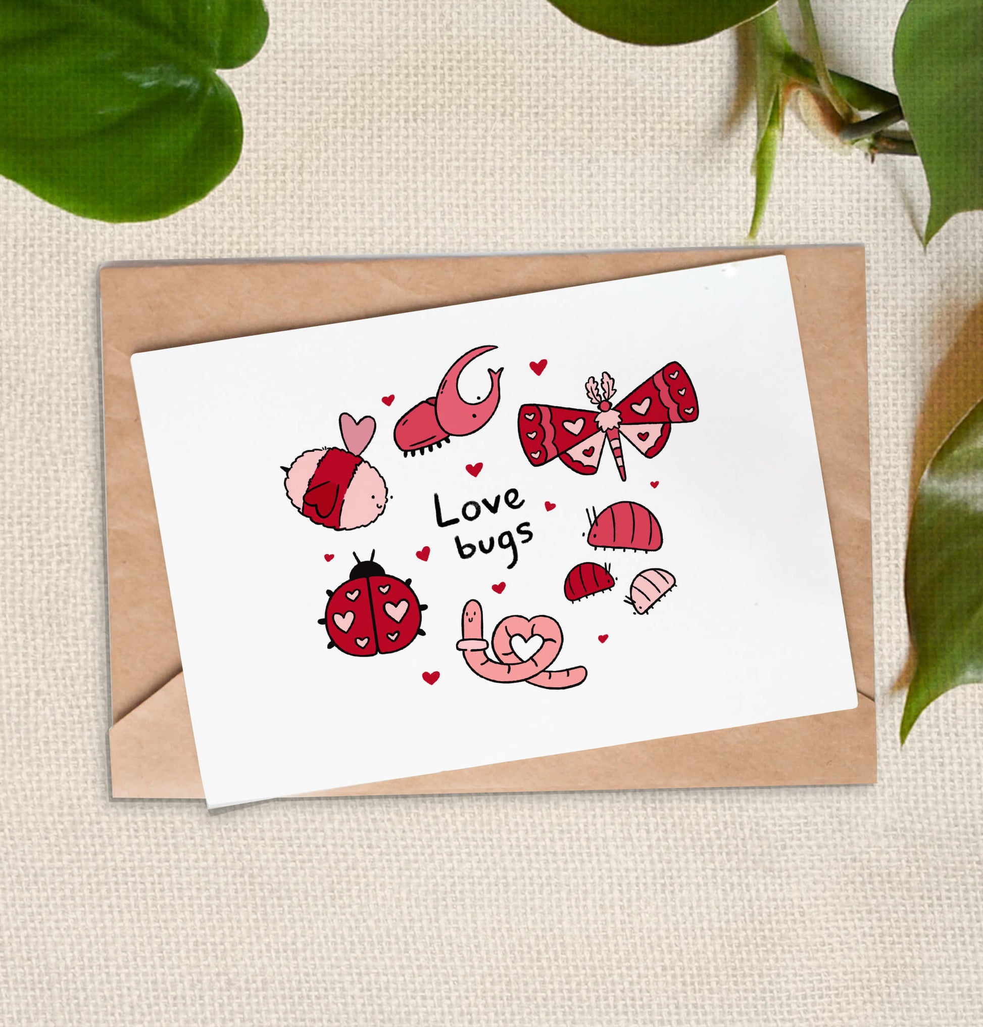 Greeting card of 9 red and pink bugs, including a worm, bee, and moth, with the text "love bugs" surrounded by hearts.
