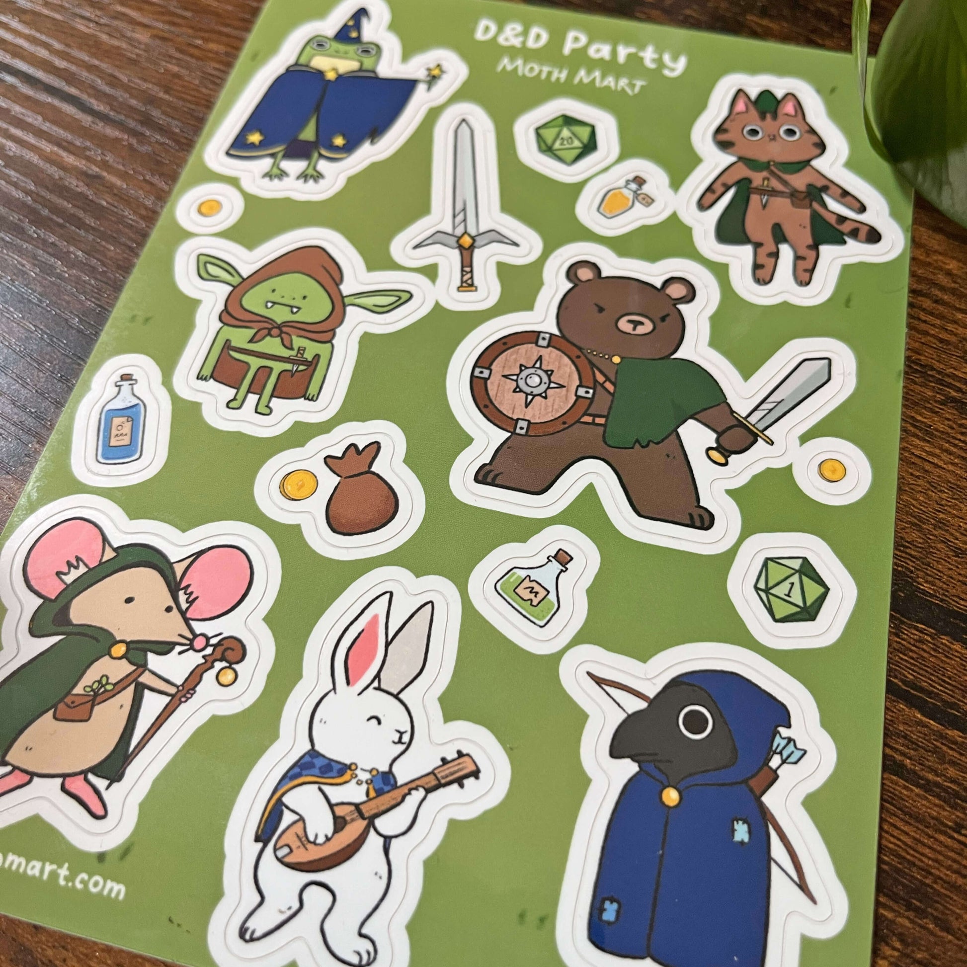 Sticker sheet with fantasy animal dnd cartoon characters on a green background, sitting on a wood backing. 