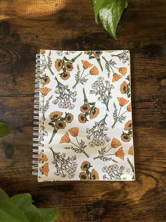 A5 reusable sticker book depicting multiple bundles of two California poppies, three sunflowers, and bundles of daisies.