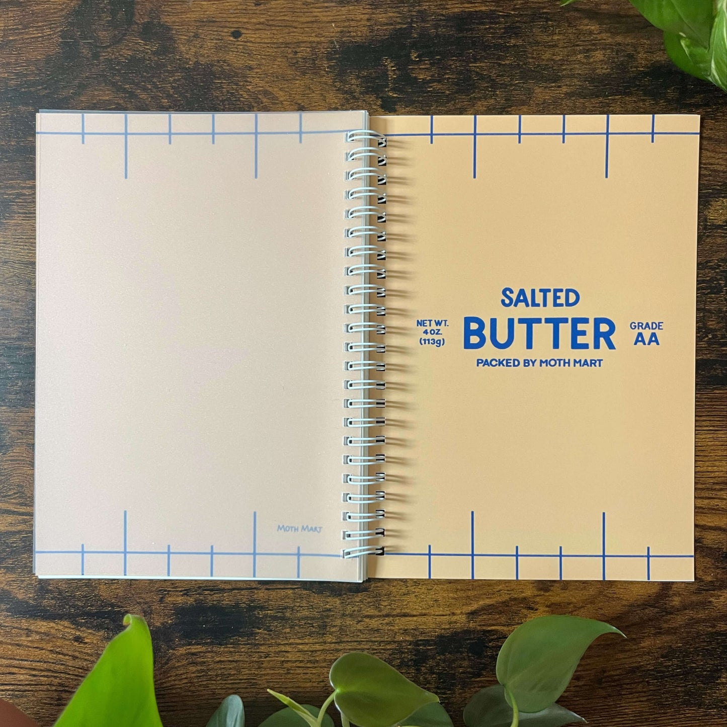 Reusable sticker book with 'Salted Butter' as the cover on a wooden surface with plants.