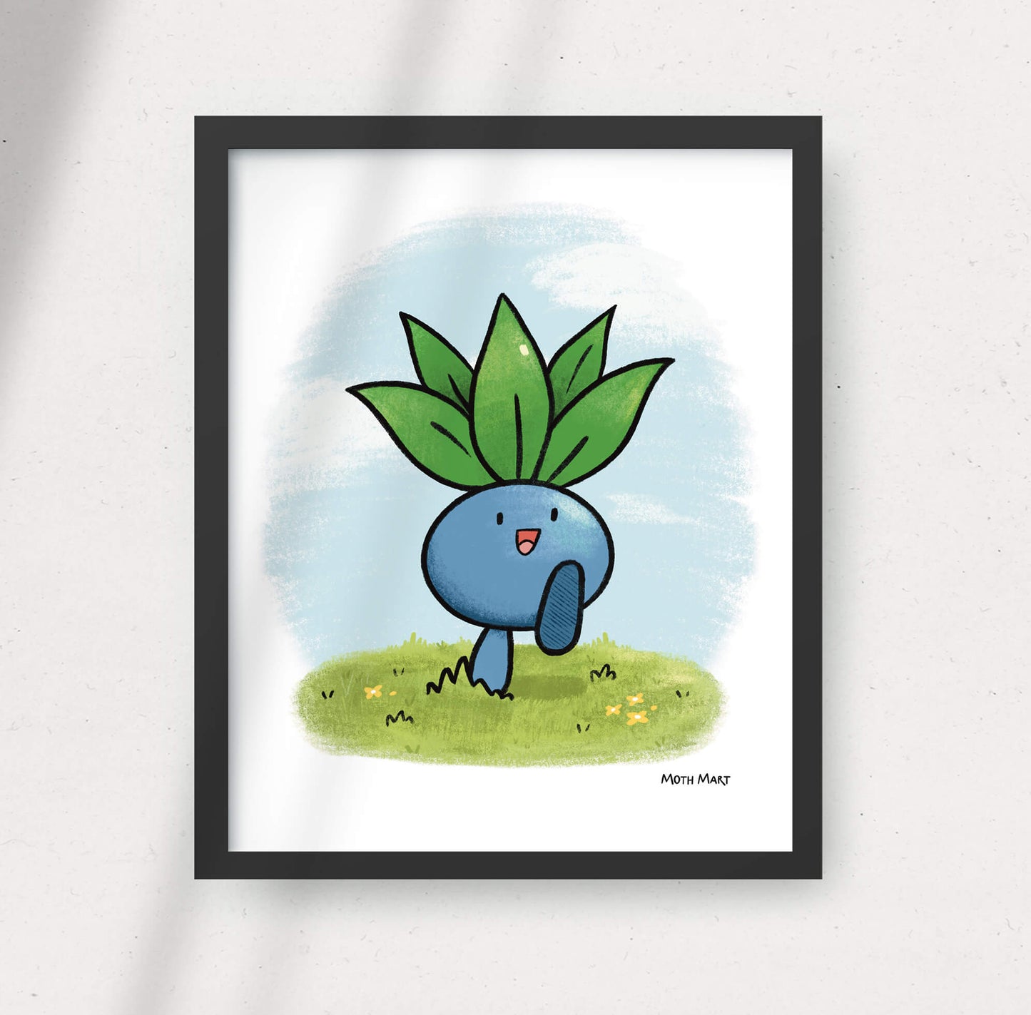 Framed illustration of a blue creature with green leaves on a white background