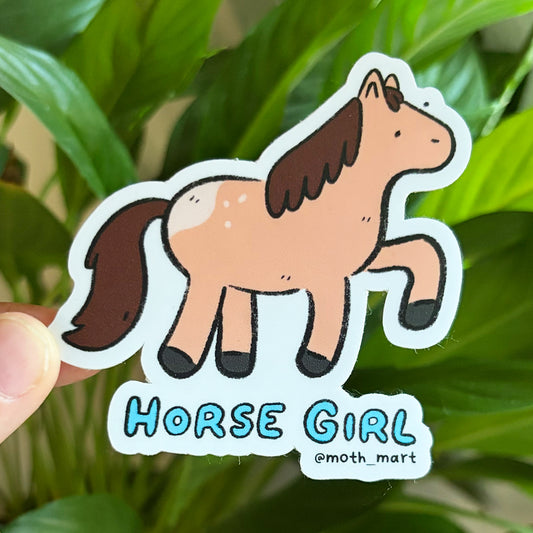 Sticker of a brown cartoon horse that says "Horse Girl" on a leafy background.