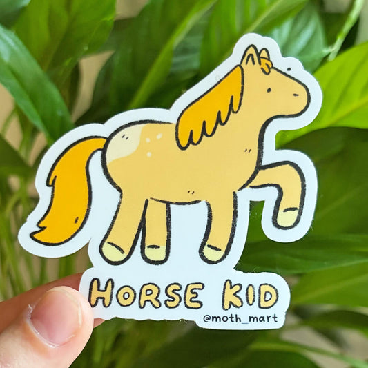 A die-cut sticker featuring a cartoon horse with the text 'HORSE KID' and '@moth_mart', held by a hand in front of green plant leaves.
