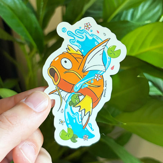 Orange koi fish dye cut sticker featuring the fish jumping out of water. Held against a green, leafy background