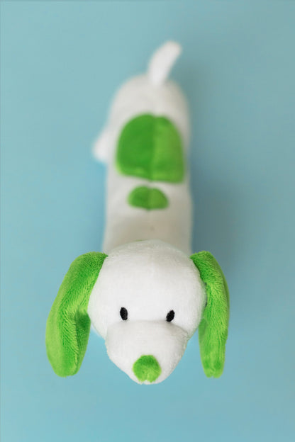 Plush toy resembling a dog with green accents on a light blue background