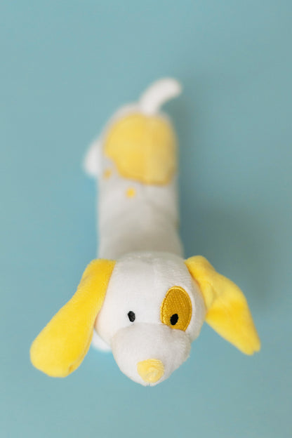 Plush toy resembling a dog with yellow accents on a light blue background