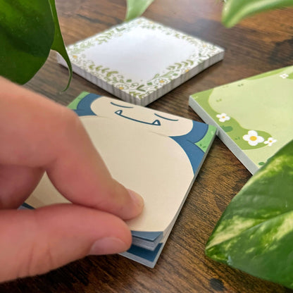 Peeling a sleeping normal type sticky notes pad, mainly showing his belly with more decorative pads nearby. 