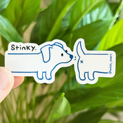 Dye cut sticker of a wiener dog sniffing another dog with the text "stinky", held against a background of house plants. 